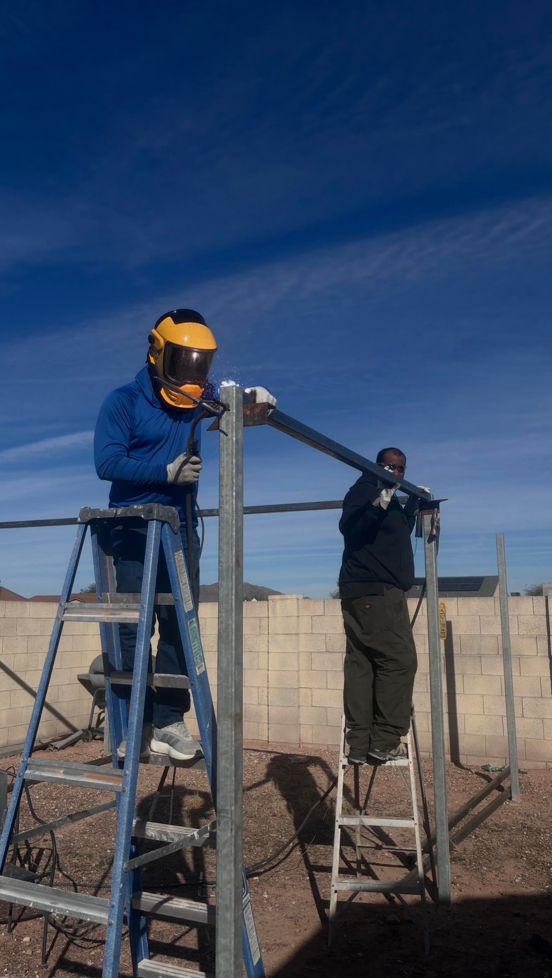 The Caribbean Brothers Steel crew welding a steel gate frame on site