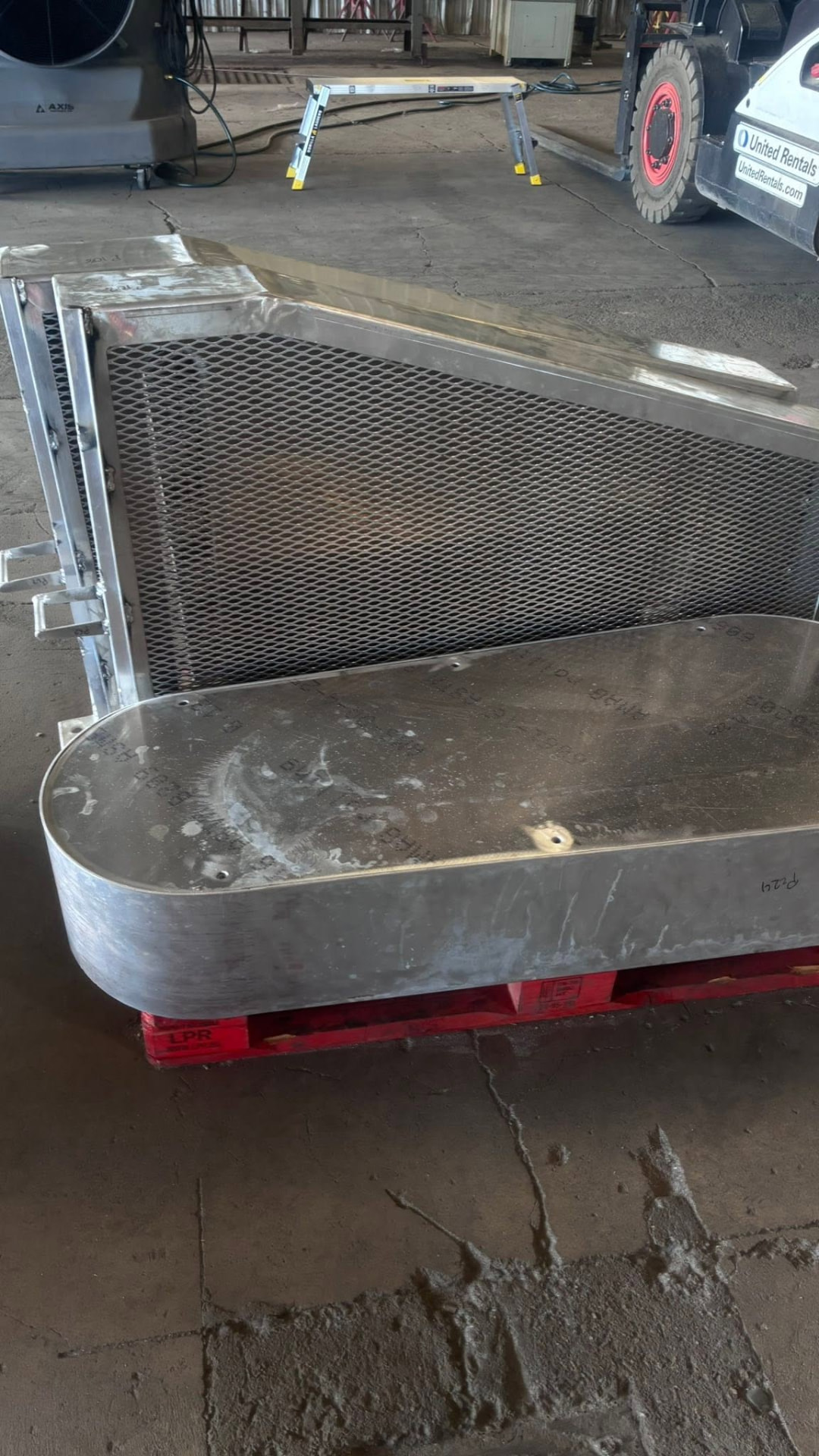 Large aluminum housing with expanded metal mesh panel on a pallet