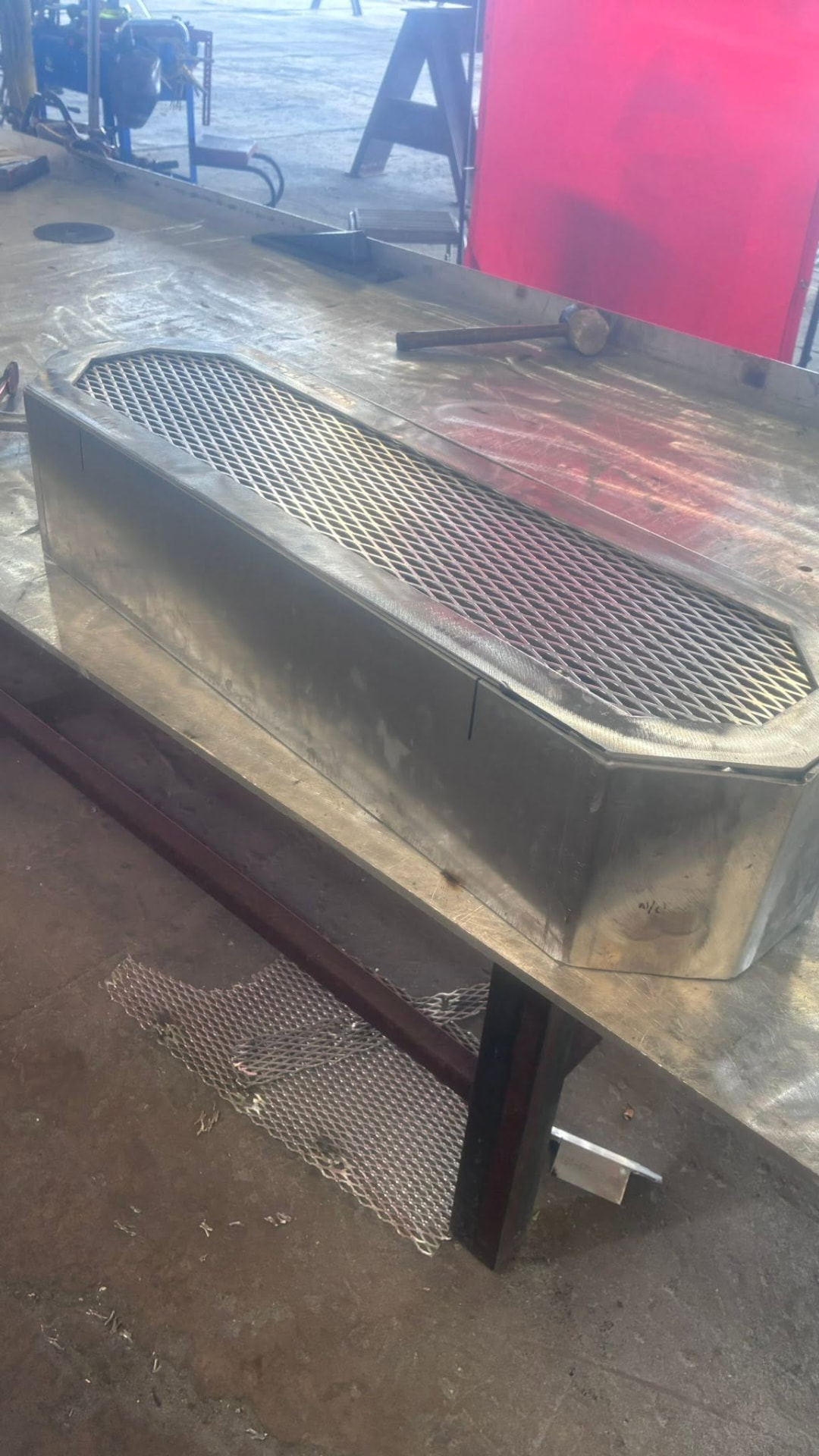 Stainless steel enclosure with a mesh vent top on the fabrication table