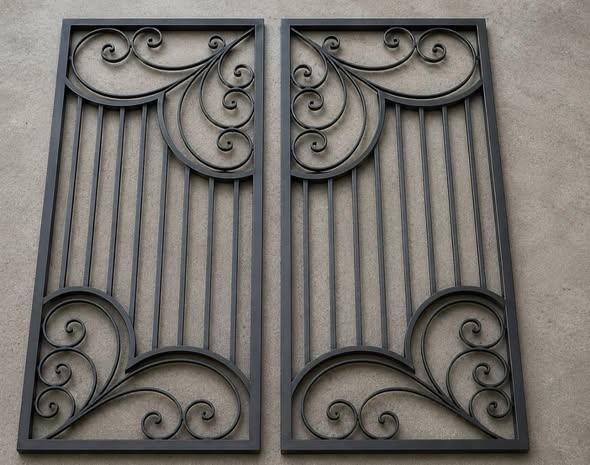 Pair of matte black decorative iron panels with scroll corners